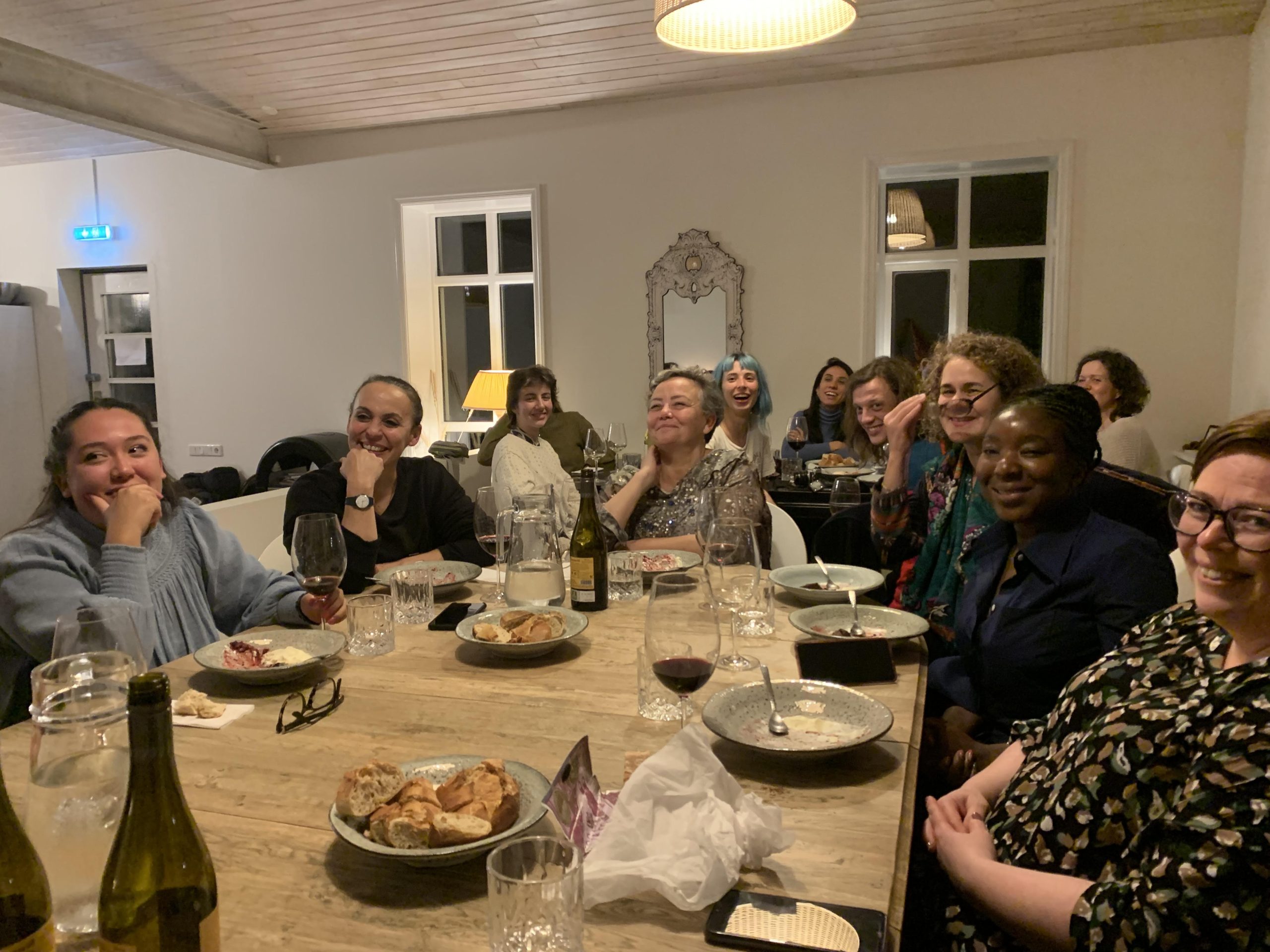 People at a dinner table - laughing